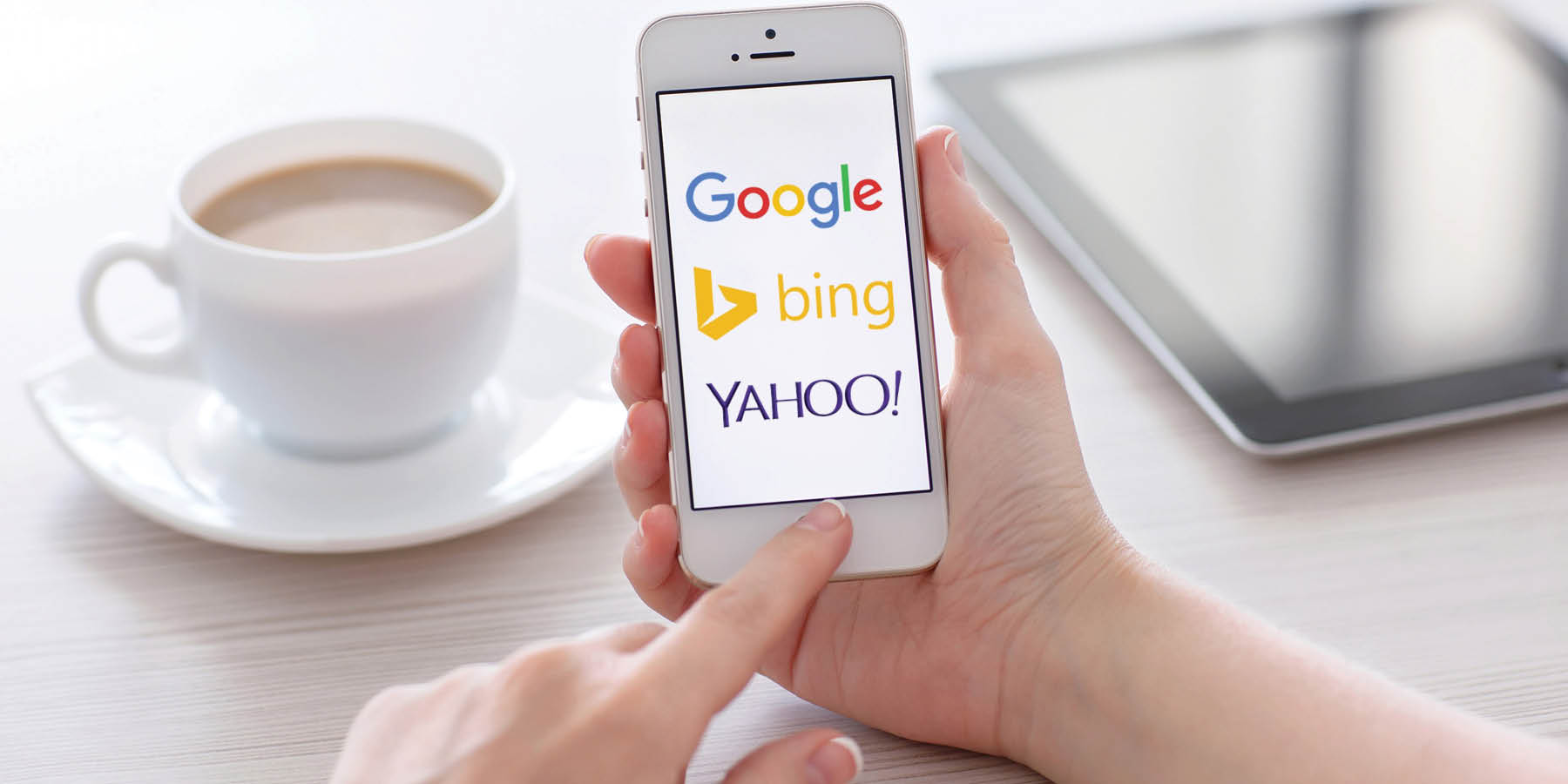 female-hands-holding-iphone-showing-3-main-search-engines-google-bing-and-yahoo